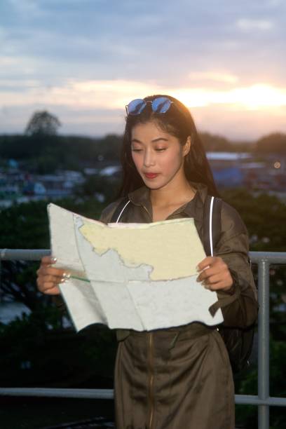 istock Pretty Asian female soldier looking map on a ship. 1159519166
