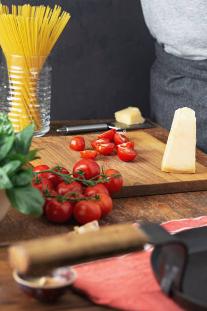 istock Raw pasta with ingredients for cooking Italian spaghetti in kitchen 1159521913
