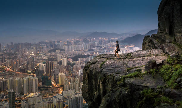 young asian tourist adventure take photo of the hongkong cityscape skyline at suicide cliff the famaus tourist place in hong kong - hong kong skyline panoramic china imagens e fotografias de stock
