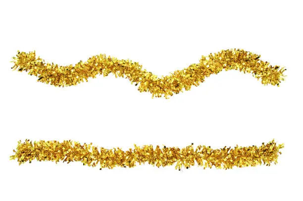 Photo of Christmas gold tinsel for decoration. White isolate