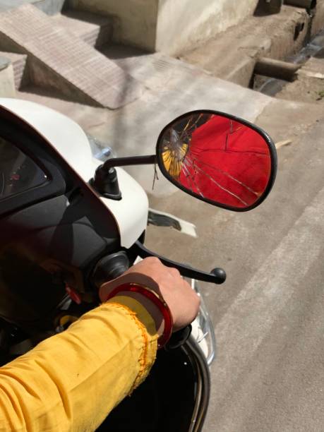 Image of damaged smashed cracked wing mirror on moped motorbike / scooter scootie bike handlebars, broken after road traffic accident RTA collision, Indian rider driving through chaotic busy streets of New Delhi, North India, with road and pavement Stock photo Image of damaged smashed cracked wing mirror on moped motorbike / scooter scootie bike handlebars, broken after road traffic accident RTA collision, Indian rider driving through chaotic busy streets of New Delhi, North India, with road and pavement broken side view mirror stock pictures, royalty-free photos & images