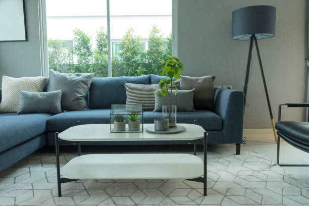 istock Modern blue sofa and grey pillow with coffee table and floor lamp. 1159526724