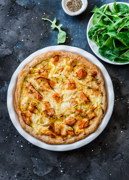 istock Smoked trout, potatoes, leek pie on dark background, top view 1159528076