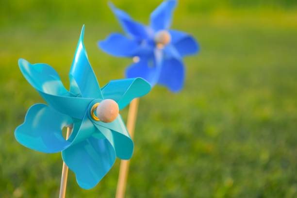 istock Little toy windmills with green background 1159532086