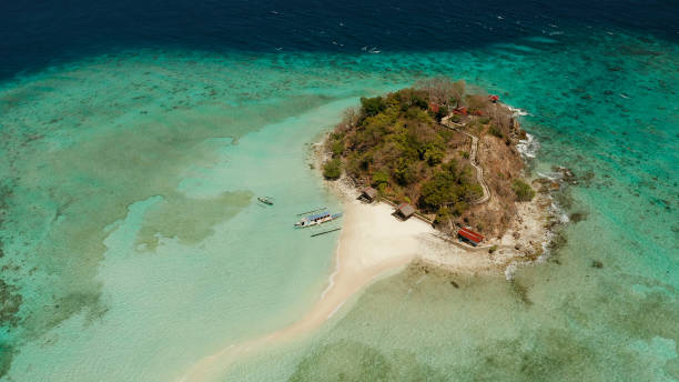 istock Small torpic island with a white sandy beach, top view 1159533253