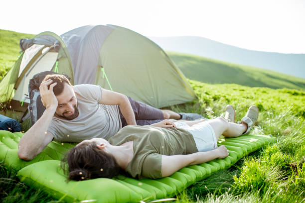 istock Couple relaxing at the campsite in the mountains 1159536982