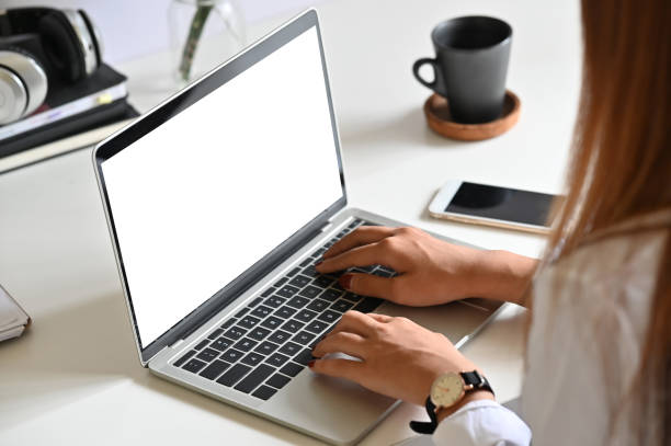 istock Woman using mockup laptop computer on office desk. 1159538201