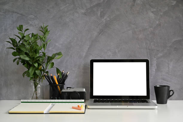 istock Mockup laptop on workspace with office supplies and loft wall. 1159538212
