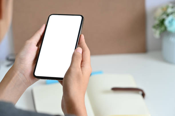 istock Cropped shot woman using mockup smartphone on office desk. 1159538348