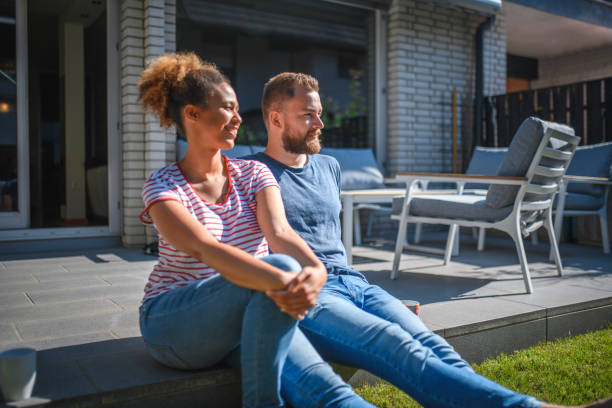istock Young Adult Couple Talking With Coffee on Their Back Deck 1159539314
