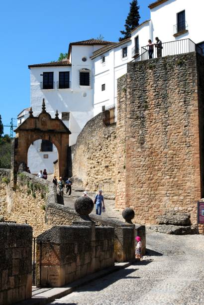 Old bridge and Philip V arch, Ronda, Spain. View along the old bridge towards the Philip V arch, Ronda, Malaga Province, Andalucia, Spain, Europe. prince phillip stock pictures, royalty-free photos & images