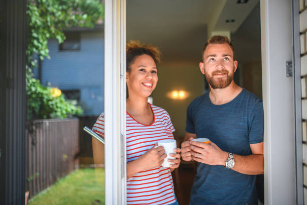 istock Young Couple Enjoying Coffee and Dreams of a Backyard Deck 1159539395