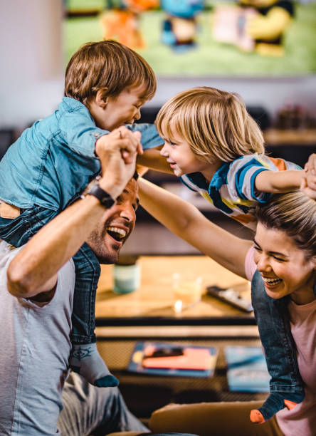 istock Playful parents having fun with their small sons at home. 1159543803