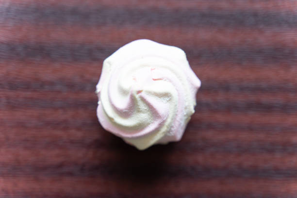 Delicate white-pink marshmallow . white plate with marshmallows on the table close-up