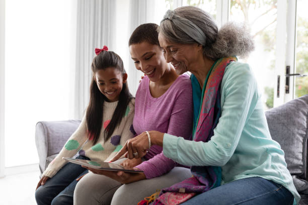 istock Multi-generation family using digital tablet on a sofa in living room 1159547512