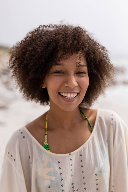 istock Happy woman standing on the beach 1159548448
