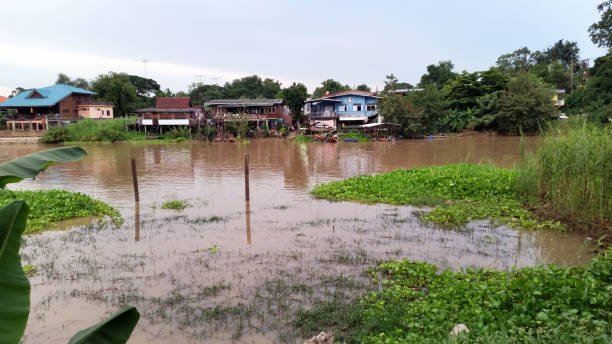 istock small house by the river, Thailand 1159550411