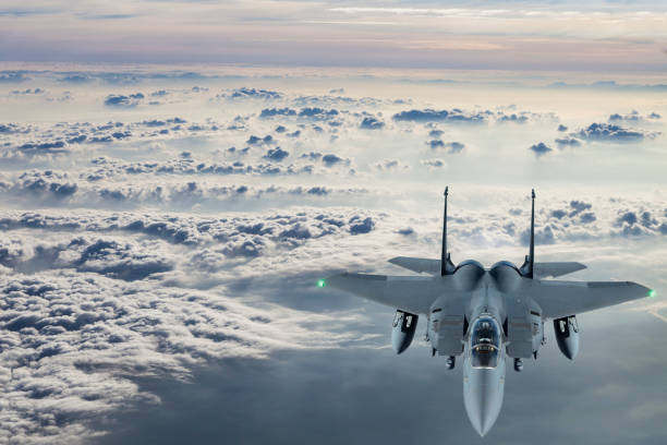 istock F-15 Figter Jet flying at sunset 1159550643
