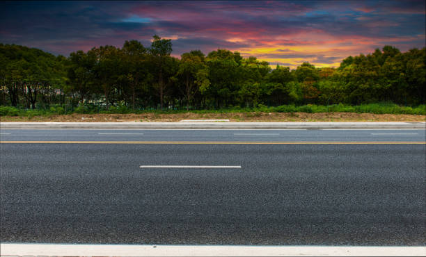istock New asphalt roads, trees under blue sky and white clouds 1159550904