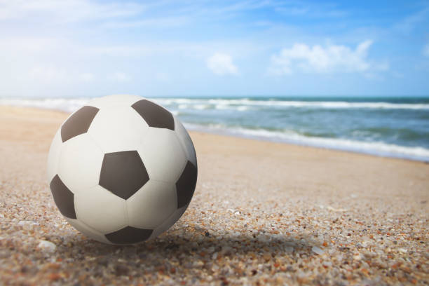 istock Soccer ball object are placed on beach and bright sky 1159551103