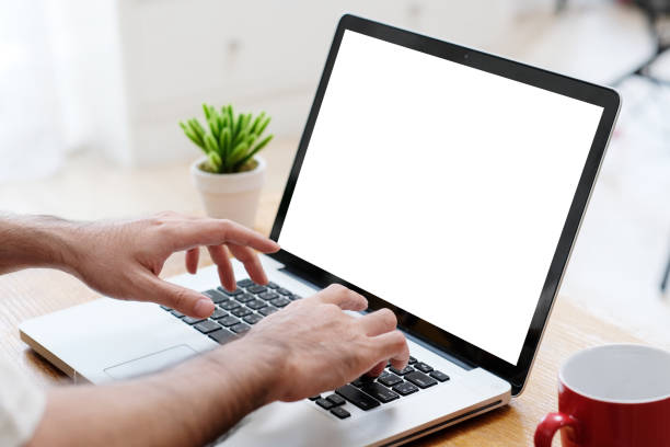 istock Man hands using laptop computer with blank screen for mock up template background, business technology and lifestyle background concept 1159551980