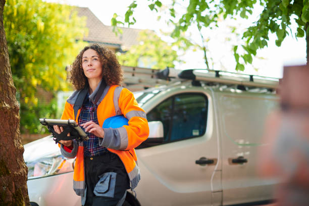 female heating engineer arrives at job female heating engineer arrives at job reflective clothing photos stock pictures, royalty-free photos & images