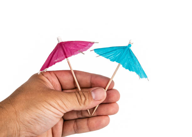 istock Holding cocktail umbrella in the hand 1159552339