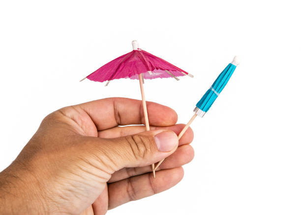 istock Holding cocktail umbrella in the hand 1159552344