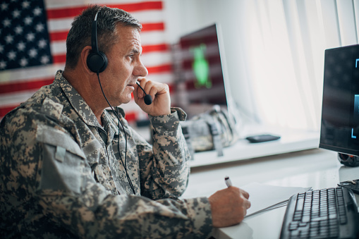 Senior soldier with headphones working