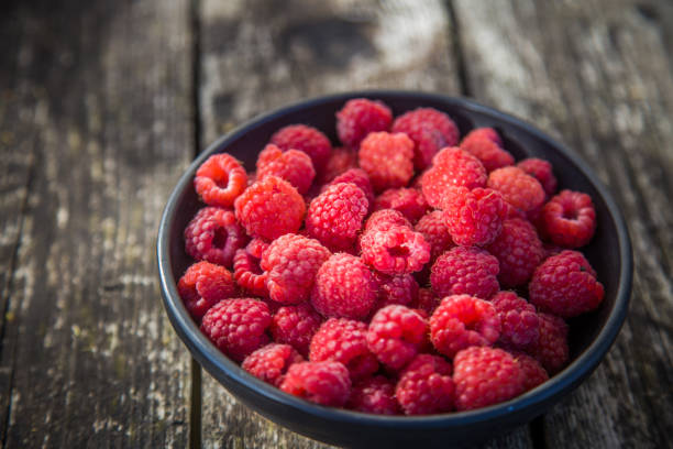 istock Beautiful, freshly picked garden raspberries in the summer. 1159553576