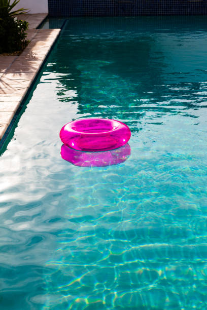 Inflatable tube floating in a swimming pool in backyard at home