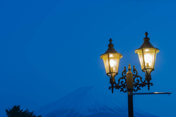 istock Close-up Street light and snow covered Mount Fuji 1159557718