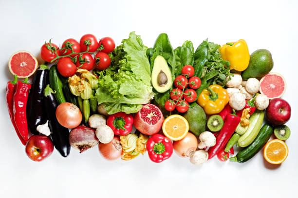 istock Mixed organic vegetables and greens isolated on white background. 1159558949