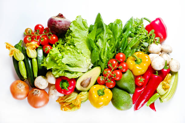 istock Mixed organic vegetables and greens isolated on white background. 1159558989