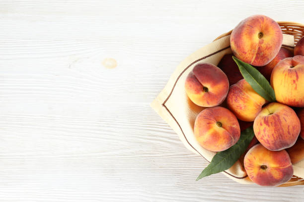 istock Minimalistic bacground with ripe juicy nectarine peaches. 1159560335