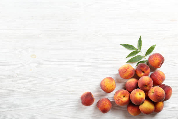 Minimalistic bacground with ripe juicy nectarine peaches.