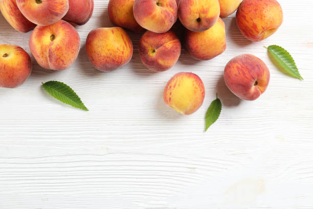 istock Minimalistic bacground with ripe juicy nectarine peaches. 1159560411