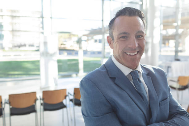 istock Businessman standing in conference room smiling to camera 1159560603