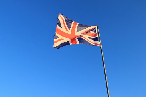 Union flag against a blue sky.