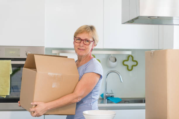 istock Content Senior Woman carrying boxes whilst moving home 1159560898