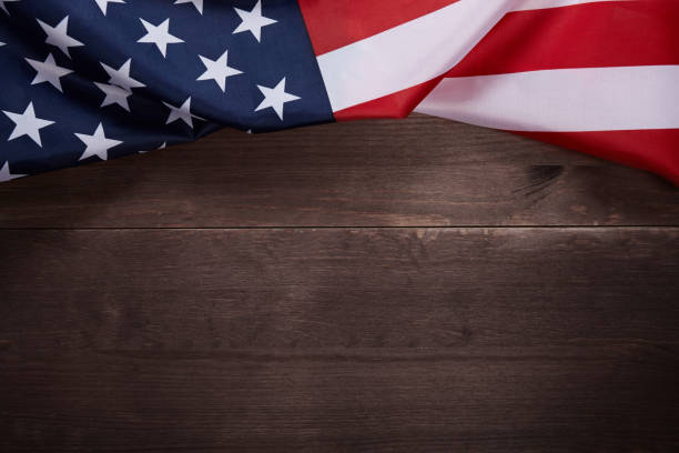 istock American flag on wooden background with copy space. 1159561706