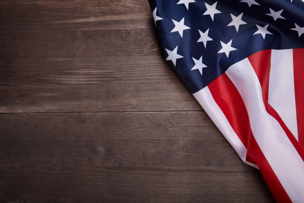istock American flag on wooden background with copy space. 1159561803