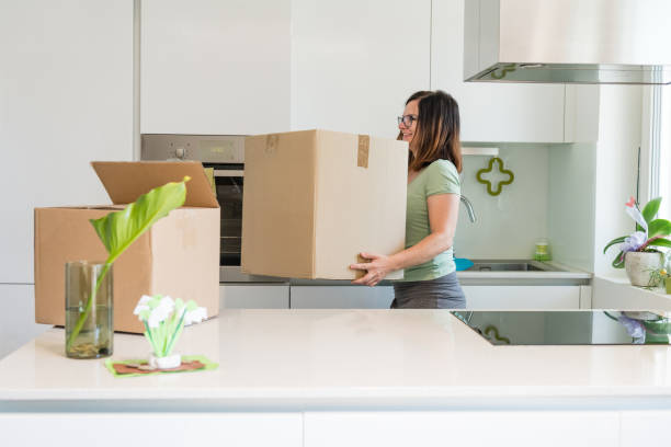 istock A woman carrying boxes whilst moving home 1159562175