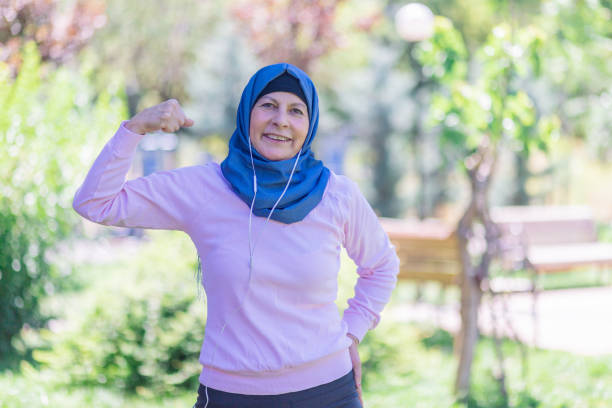 istock Muslim woman Showing biceps expressing strength 1159562196