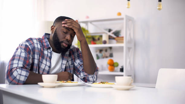 istock Tired African-American man having headache after hard day, feeling exhausted 1159562730
