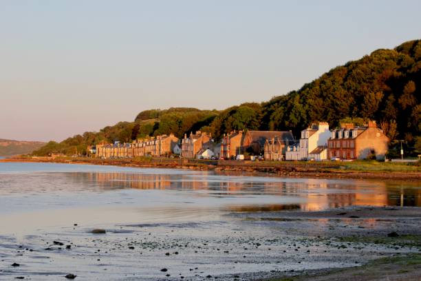 Kilchattan Bay The village of Kilchattan Bay at sunset on the Isle of Bute, Scotland. argyll and bute stock pictures, royalty-free photos & images