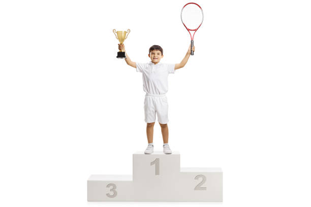 istock Boy tennis winner standing on a pedestal 1159565861