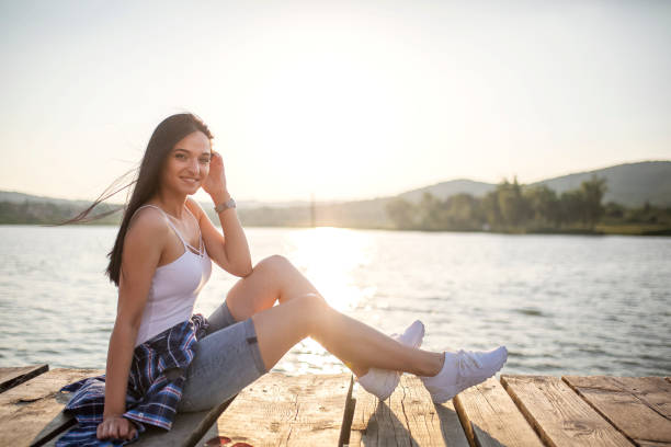 istock Young women having fun by the lake 1159566134