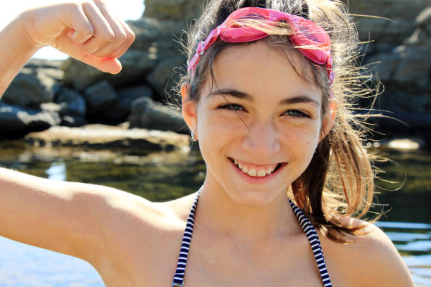 Happy girl making faces on the beach