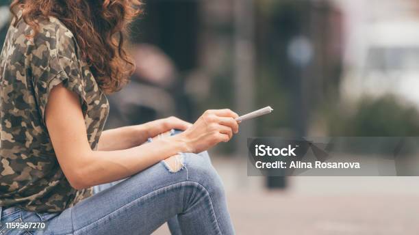 Young Female Holding A Marijuana Joint In Her Hand Ready To Smoke Urban Weed Smoking Stock Photo - Download Image Now